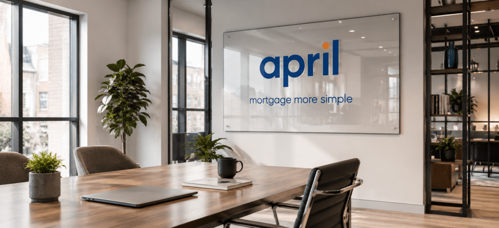 Further Borrowing hero image showing a modern office meeting room with April branding displayed on a large glass sign on the back wall.